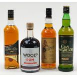 Three bottles of rum and a bottle of Clan Macgregor whiskey comprising Woods, Sailor Jerry and