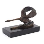 Patinated bronze study of a goose raised on a rectangular ebonised base, 17cm in length