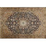 Rectangular Persian Qum silk rug having all over stylised floral design onto midnight blue and beige