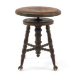 Antique American revolving piano stool on wrought iron, glass claw and ball feet, 48cm high