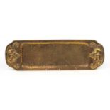 Arts & Crafts planished brass tray embossed with grotesque lion masks, 59cm wide
