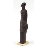 Modernist hardwood carving of a nude female raised on a rectangular onyx base, 32.5cm high