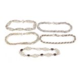 Five silver bracelets, one set with garnets, 49.0g