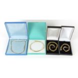 Four gold plated silver necklaces housed in gift boxes, 46.0g
