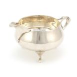 Charles Edwards, Arts & Crafts silver cream jug with stylised flower handle, retailed by Beaver Ltd,