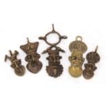 Five African Benin style brass pendants, the largest 10.5cm high