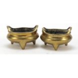 Near pair of Chinese bronze tripod incense burners with twin handles, each 12.5cm in diameter