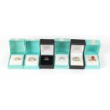 Six silver rings set with semi precious stones housed in gift boxes, various sizes, 25.4g