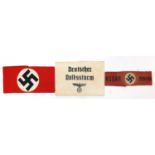 Three German military interest arm bands including a NSDAP example, the largest 21cm wide