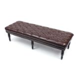 Large contemporary stool with ebonised feet and brown button leather upholstery, 45cm H x 170cm W
