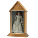 Antique wax doll in traditional dress, housed in a glazed pine case, over all 69.5cm H x 40.5cm W