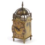 18th century brass lantern style clock engraved with flowers, the chapter ring having Roman