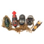 Six hand painted African carved wood face masks, the largest 46cm high