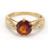 9ct gold orange stone ring with diamond shoulders, size O, 2.7g