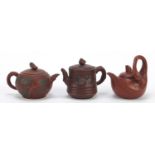 Three Chinese Yixing terracotta teapots including one in the form of a swan, each with character
