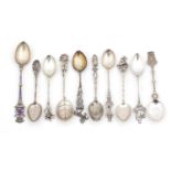 Ten Continental silver souvenir teaspoons, including one with enamelled terminal, the largest 13cm