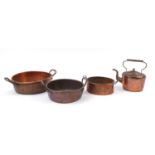 Victorian copper and brassware comprising three preserve pans and a kettle, the largest 49cm wide