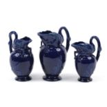 Graduated set of three Victorian aesthetic swan jugs having blue glazes, each with diamond lozenge