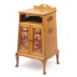 Liberty & Co, Arts & crafts oak night stand having copper handles and doors embossed with stylised