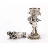 Silver plated Putti design wager cup and a model of two Dachshunds, the largest 14cm high