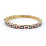 Indian silver gilt diamond and pink stone hinged bangle, 7cm in diameter, 21.8g
