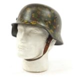 German military interest tin helmet with SS decal and leather liner, impressed 166 and inscribed