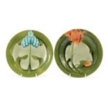 Mintons, two Secessionist pottery plates hand painted with stylised flowers, each 23cm in diameter