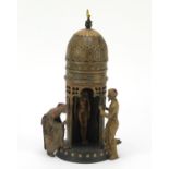 Cold painted bronze of two Arab men peeking at a nude female behind a revolving curtain, in the