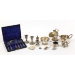 Silver plate including a pair of dwarf candlesticks, three piece cruet set and cased cutlery