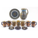 Quimper, French Art Deco pottery including a jug, seven Oddeta mugs and a tray, the largest 21cm
