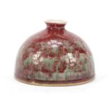 Chinese porcelain beehive water pot having a sang de boeuf glaze, 9.5cm high