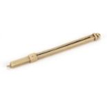 9ct gold propelling swizzle stick with engine turned decoration, 6.4g
