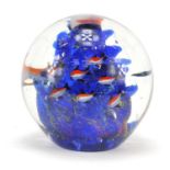 Large colourful glass paperweight decorated with fish swimming, 15.5cm high