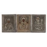 Three Russian Orthodox icons with applied silver mounts, each marked Aleksandr Timofeyevich