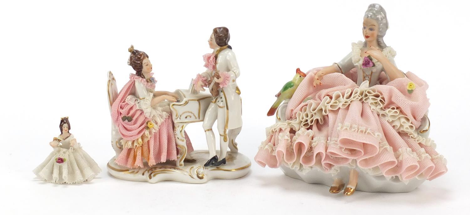 Dresden, three German porcelain lace figurines including a group of two lovers, the largest 18cm