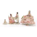 Dresden, three German porcelain lace figurines including a group of two lovers, the largest 18cm