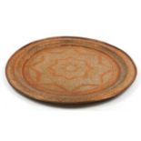 Large Islamic copper charger profusely engraved with flowers, 86.5cm in diameter