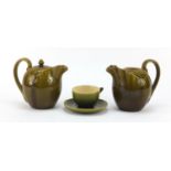 Linthorpe, two Arts & Crafts pottery jugs and a cup with saucer having green glazes in the manner of