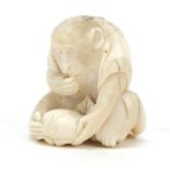 Good Japanese carved ivory okimono of a monkey holding a nut, 3.4cm high