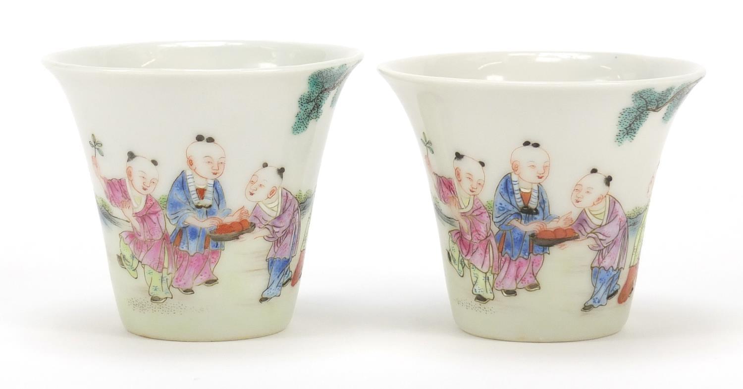 Good pair of Chinese porcelain tea cups hand painted in the famille rose palette with children