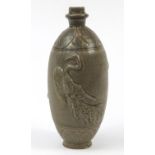 Korean stoneware vase having a celadon glaze, decorated in relief with a mythical bird, 34cm high