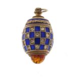 Russian silver gilt enamel and amber egg pendant set with clear stones, 3cm in length, 10.4g
