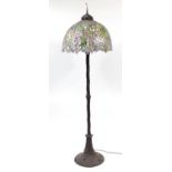 Art Nouveau design bronze standard lamp with Tiffany design leaded shade, 203cm high
