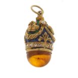 Russian unmarked silver gilt enamel and amber egg pendant, 3cm in length, 8.0g