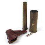 Militaria including a German gun holster and two trench shells, the largest 31cm high