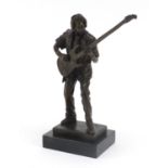 Patinated bronze figure of a guitarist raised on a black slate base, 28cm high