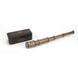 Three draw brass telescope with case, 14.5cm in length when closed