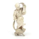 Good Japanese carved ivory okimono of a man playing with a dog, character marks to the underside,