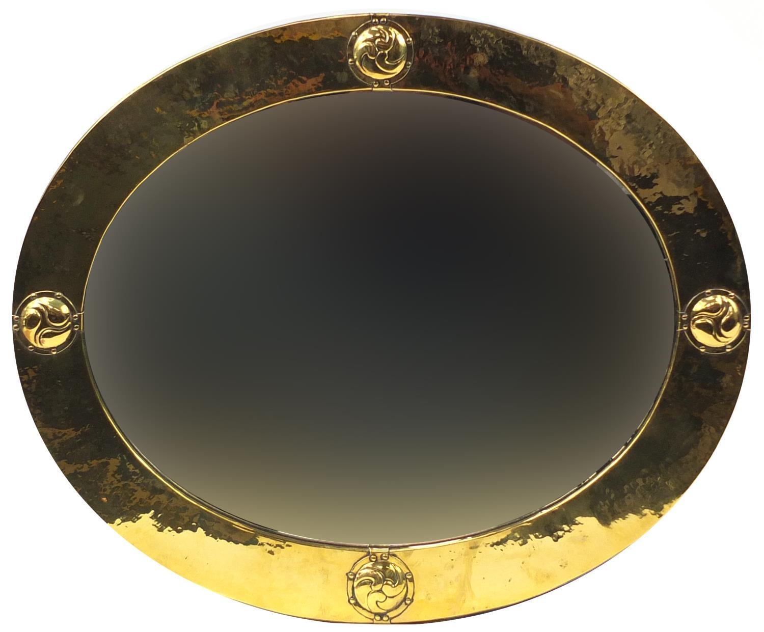 Liberty & Co, Arts & Crafts planished brass and copper mirror with embossed roundels, Liberty London