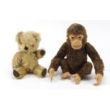 Early 20th century golden straw filled teddy bear and a monkey, probably by Steiff, the largest 32cm